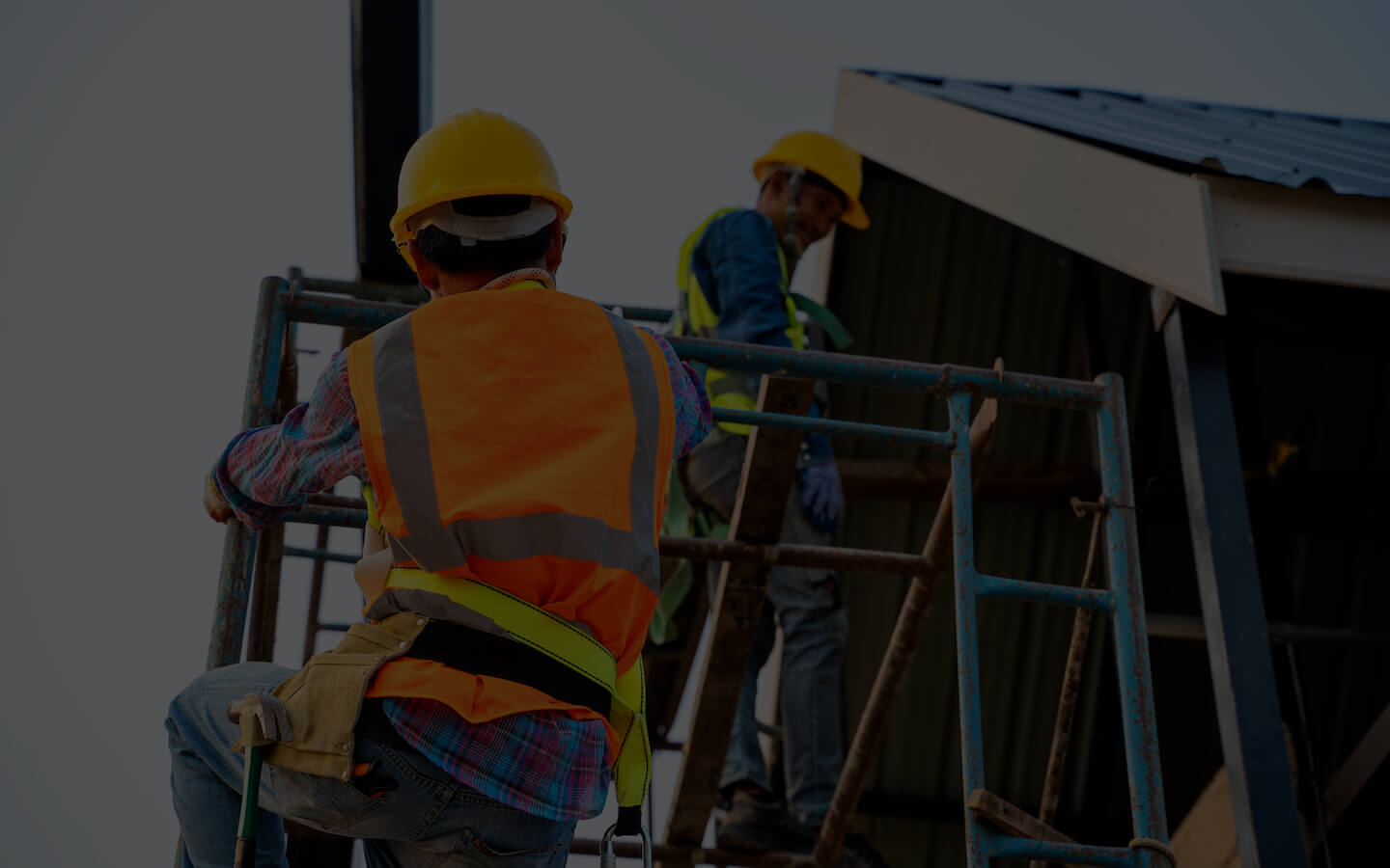 Builder working on a wooden house skeleton frame roof section