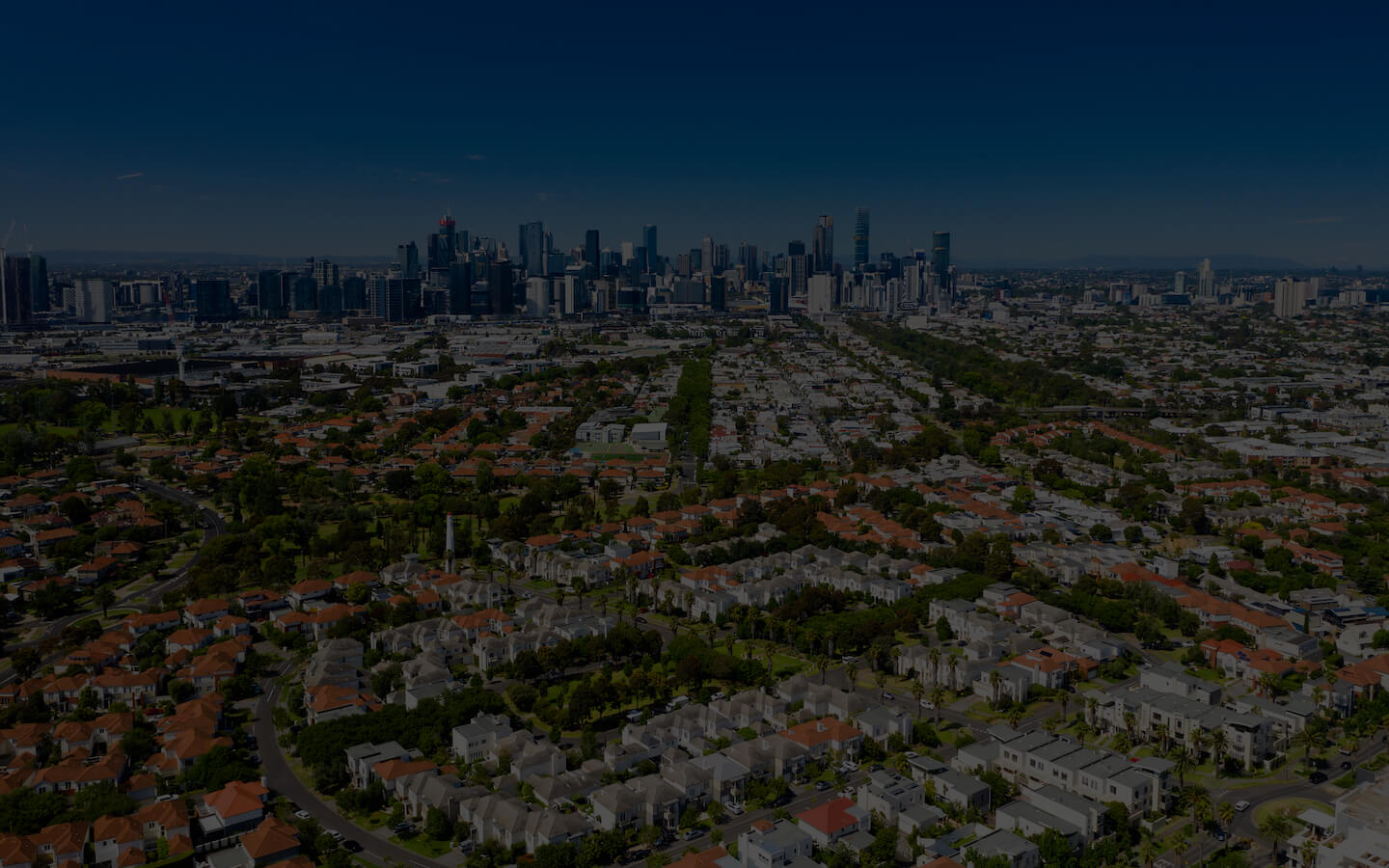 Aerial photo of Melbourne suburbs with the skyline in the distance