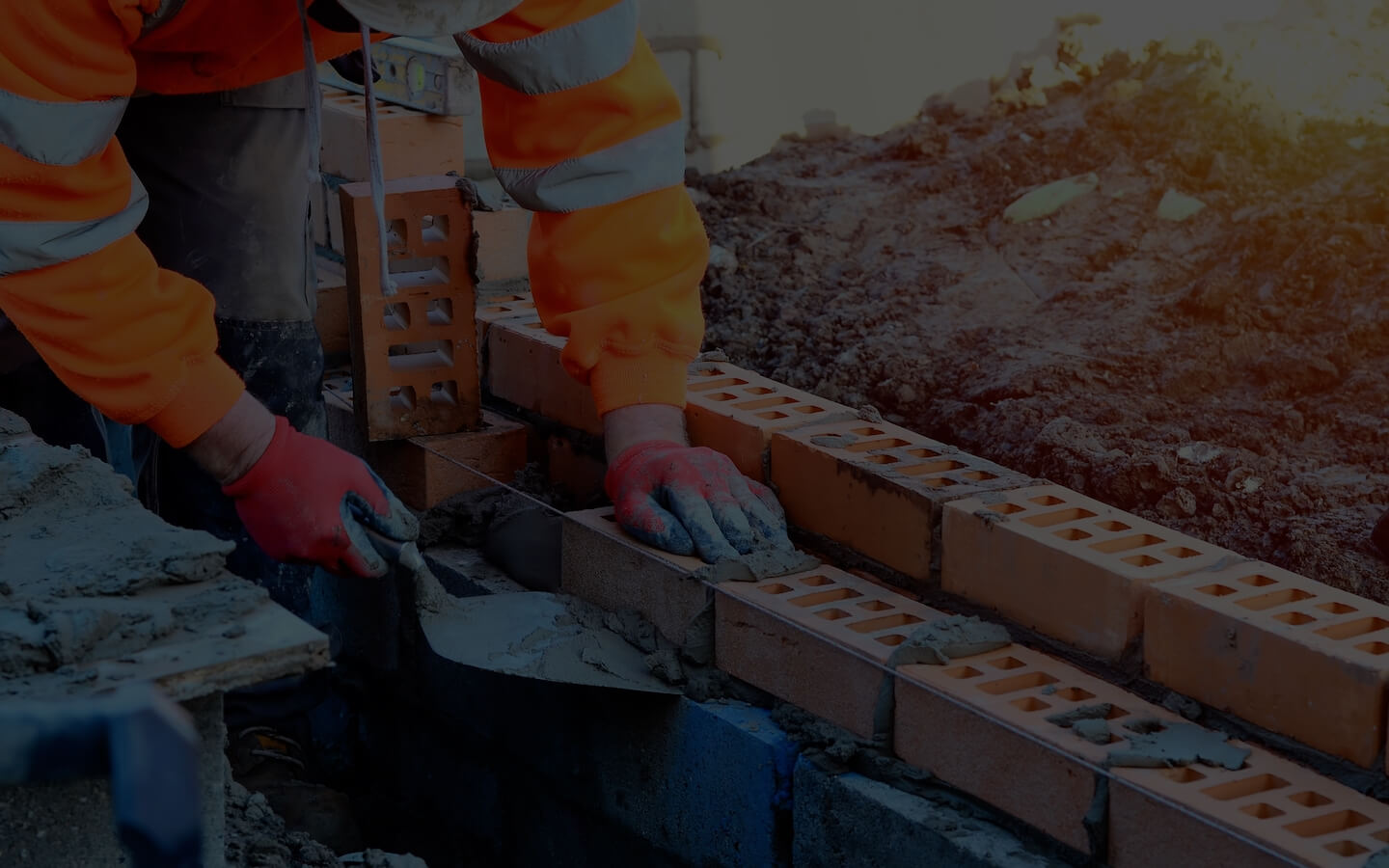 Bricklayer laying bricks on a construction site